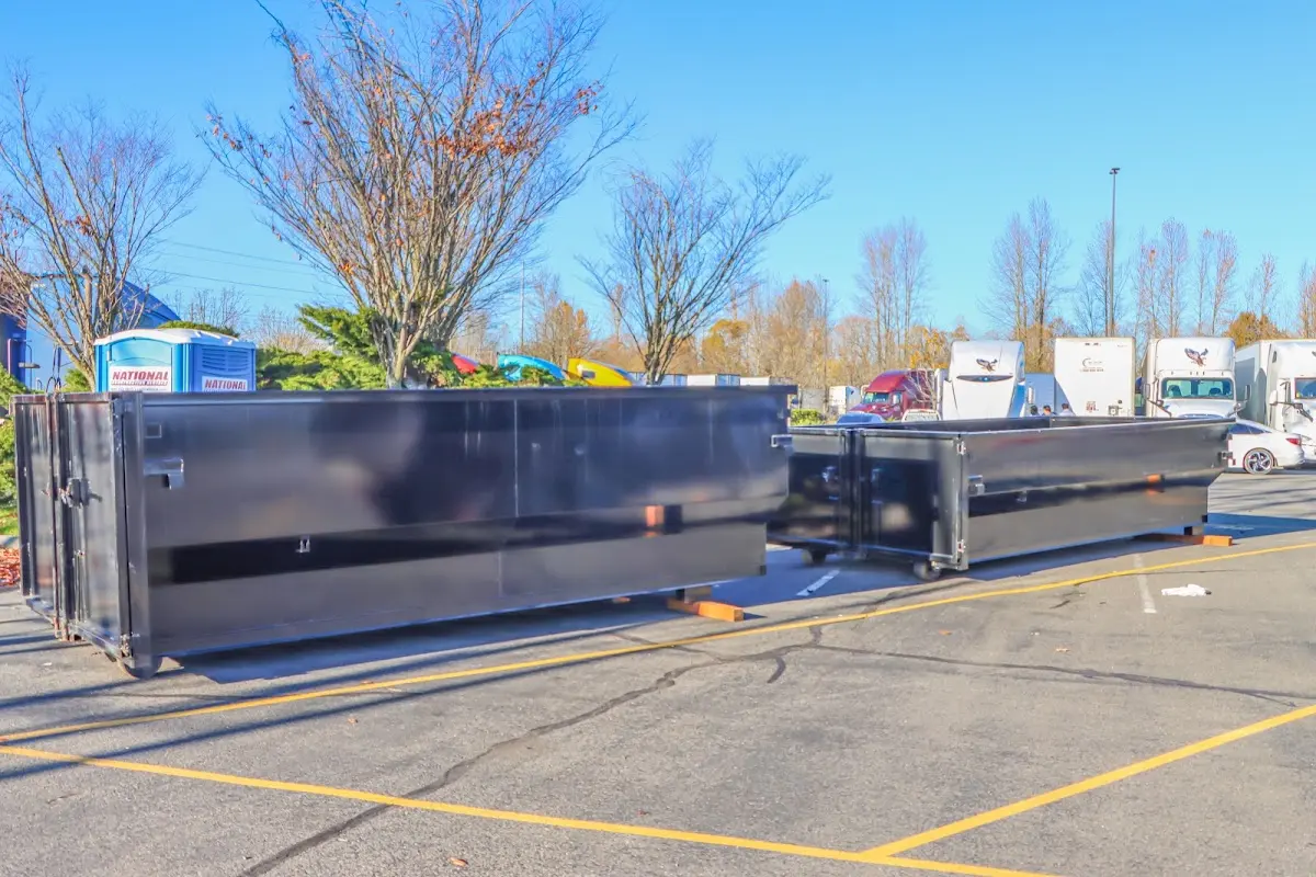 Professional dumpster rental service with roll-off container on residential driveway in Midvale